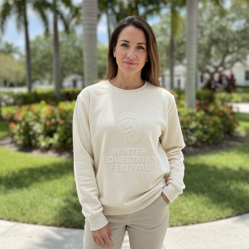 EE embossed bone WEF sweatshirt on a woman outside