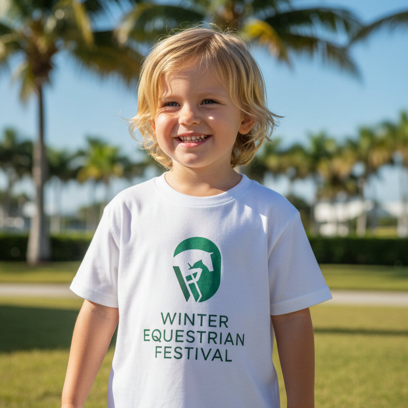 child wearing white t-shirt with 'Winter Equestrian Festival'