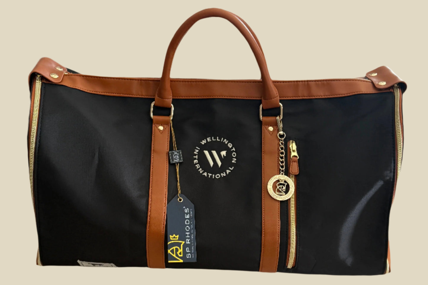 Black duffel bag with brown handles and trim on a light surface