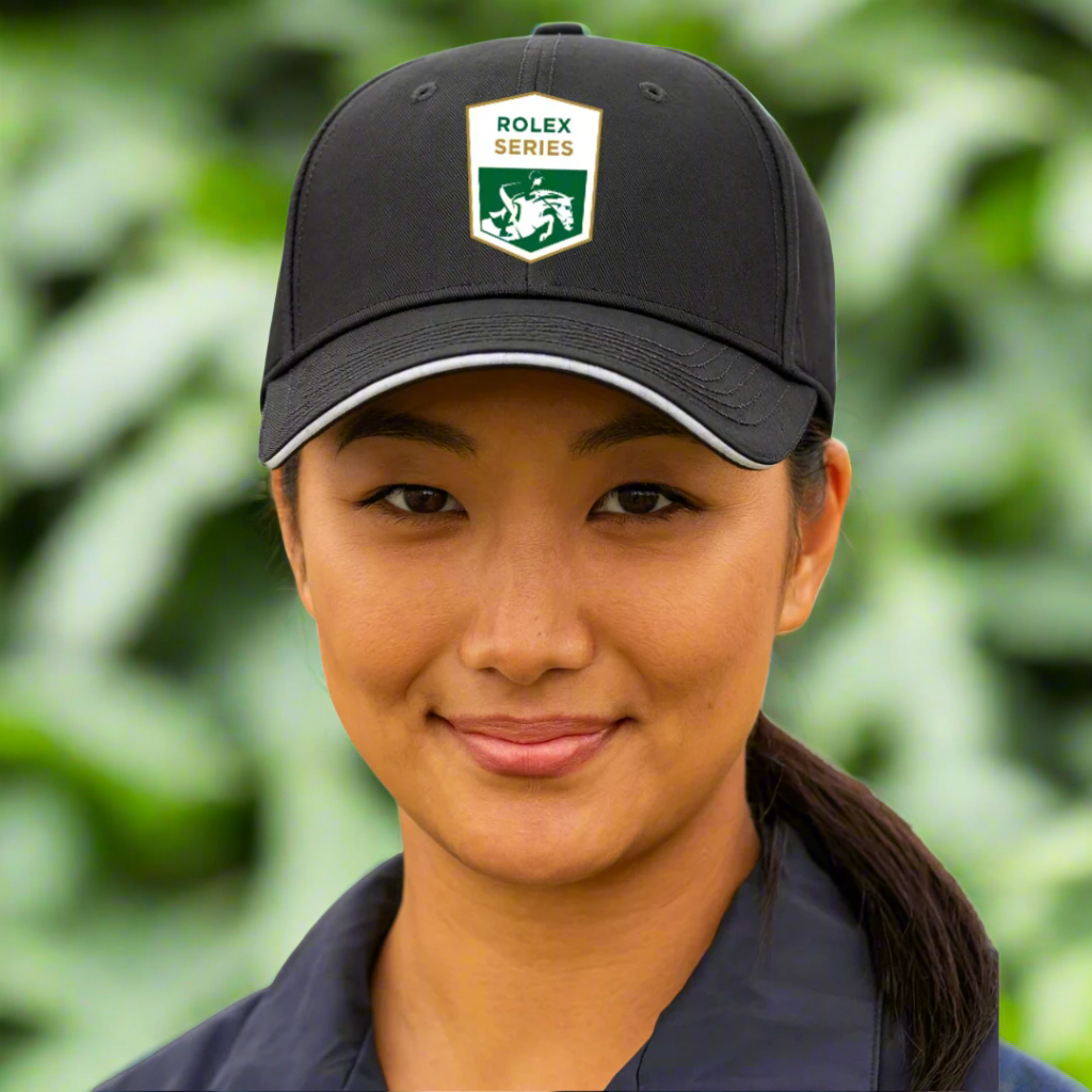 woman wearing black rolex series equestrian hat outside