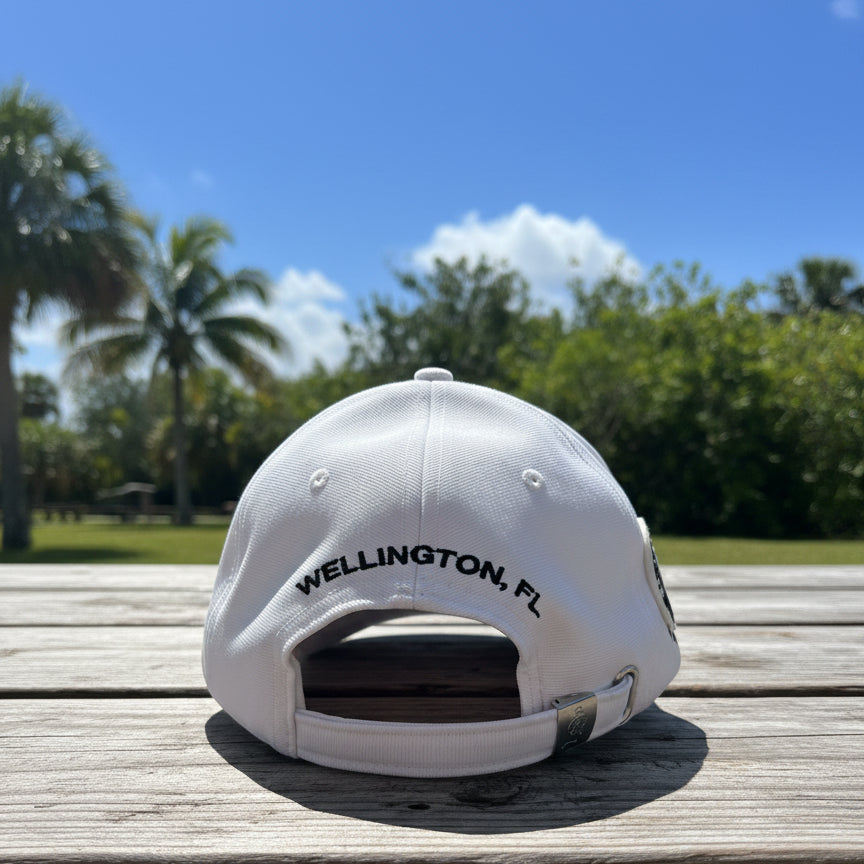 Back view of white wellington international hat outside
