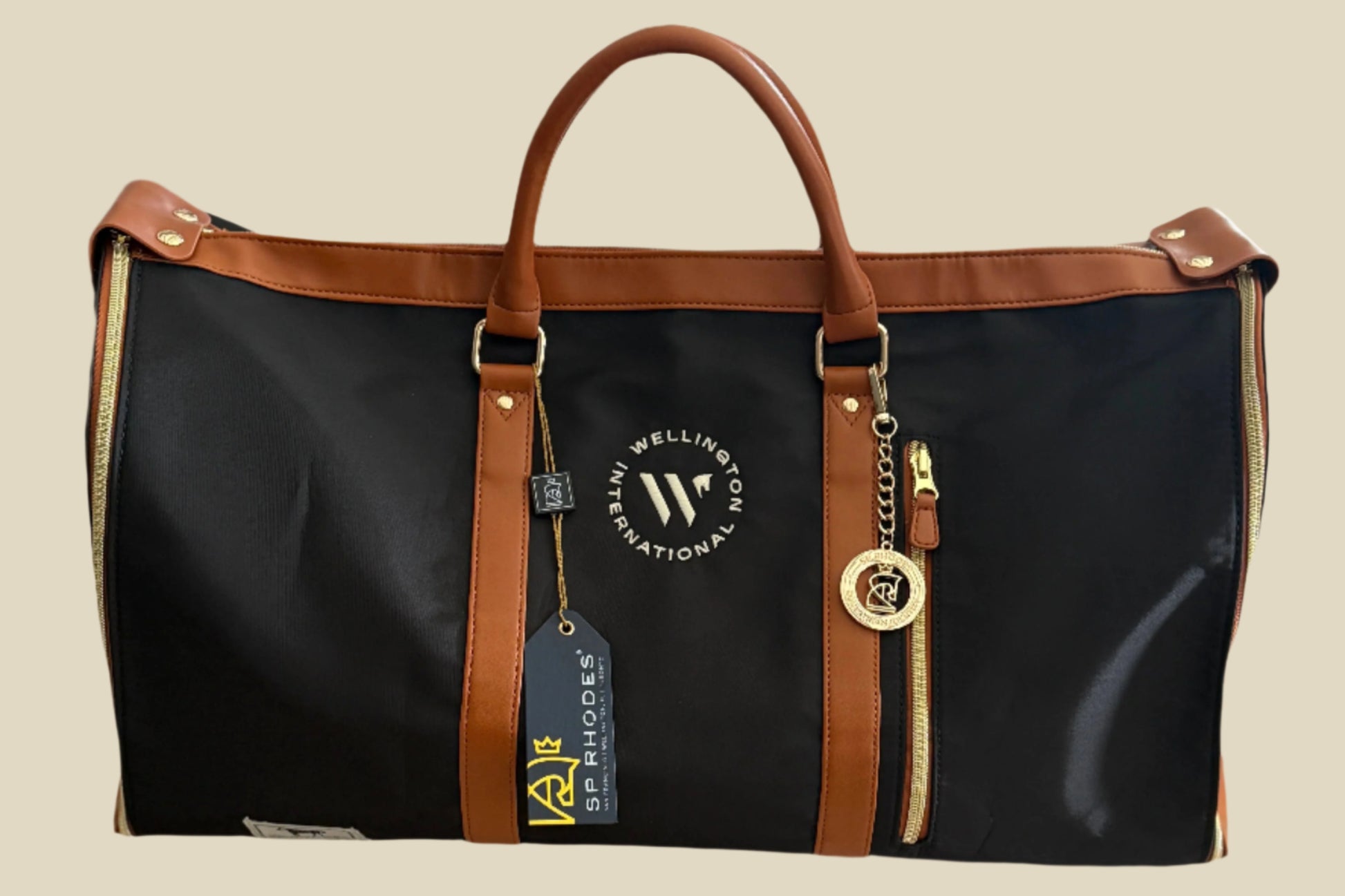 Black duffel bag with brown handles and trim on a light surface