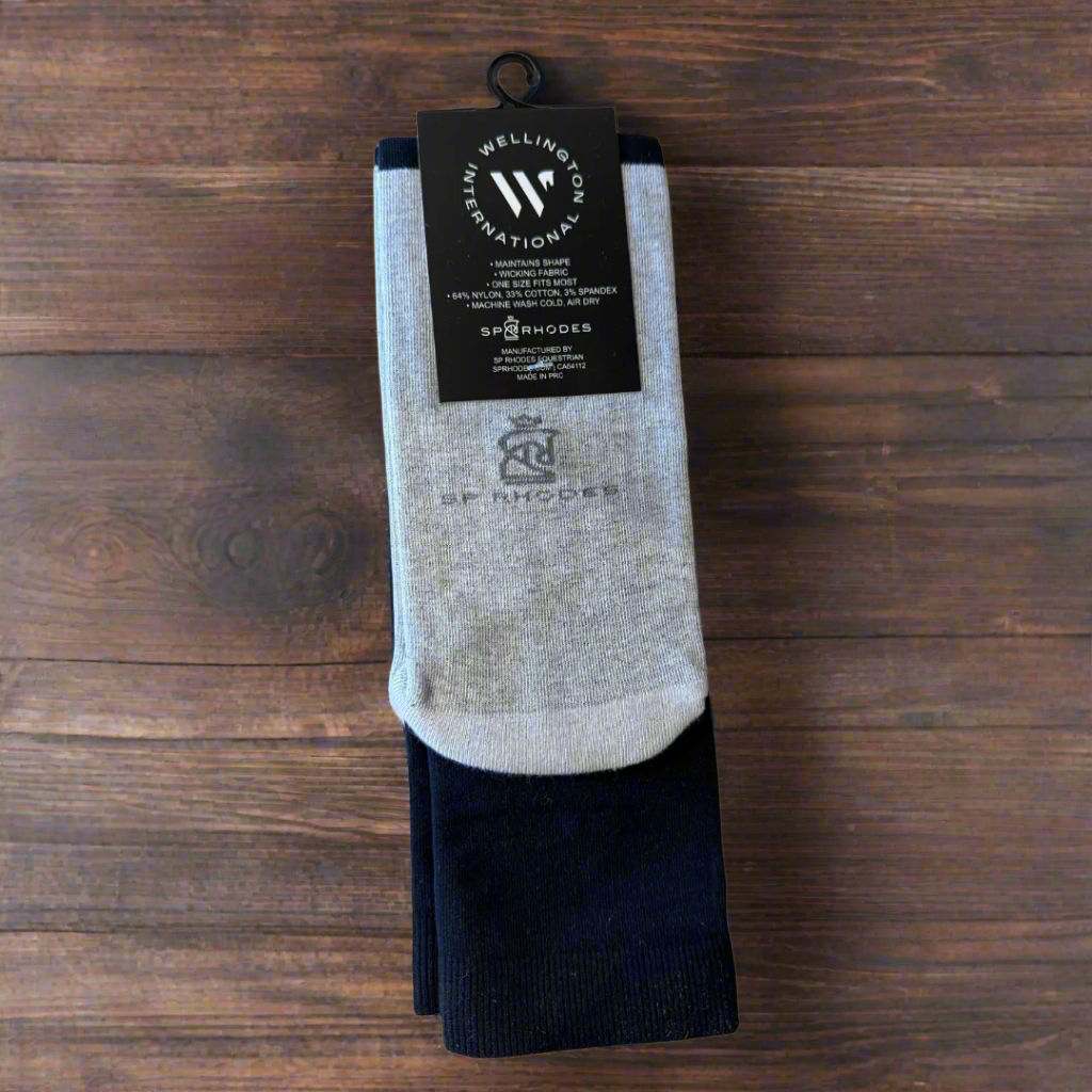 Pair of black socks with a visible brand label on a wooden background