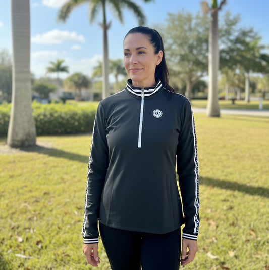 woman wearing black Wellington International Novella Mid-Weight Quarter Zip Jacket outside in florida