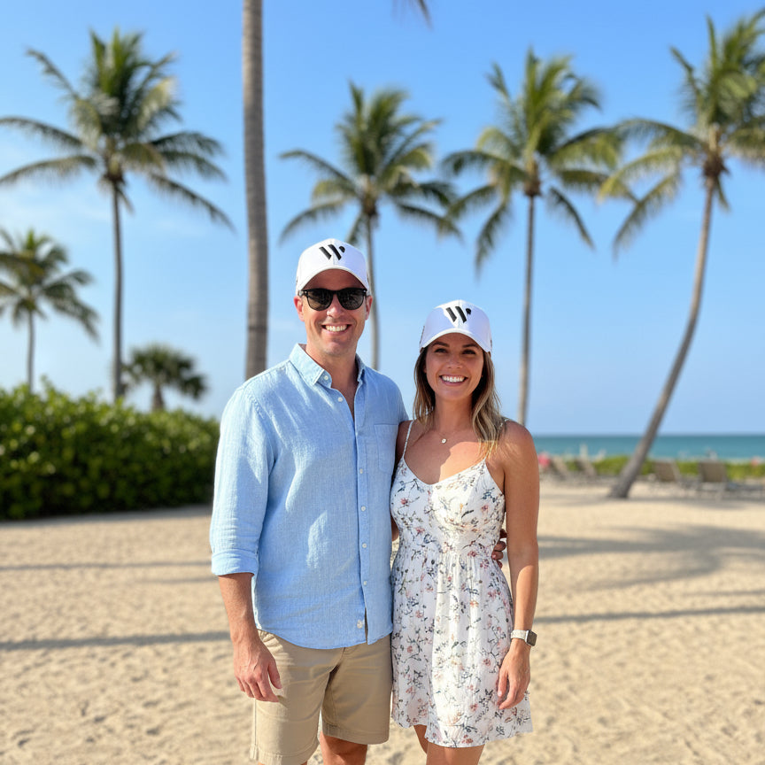 couple wearing white wellington international hats