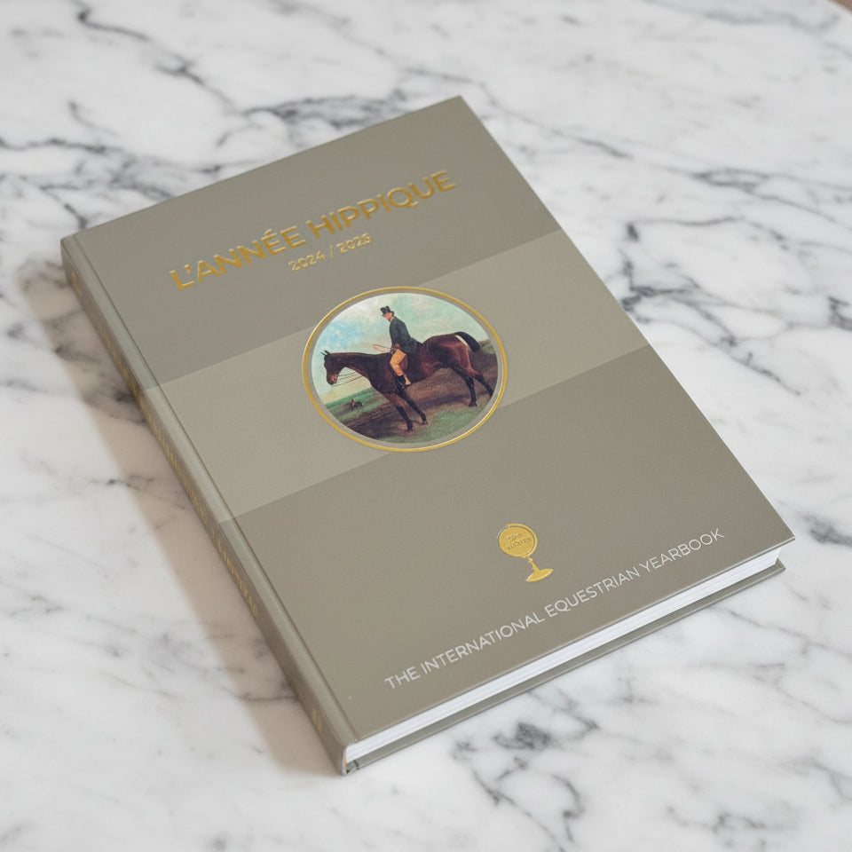 Book titled 'L'Année Hippique' on a marble surface