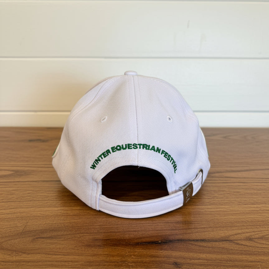 White cap with green text on a wooden table
