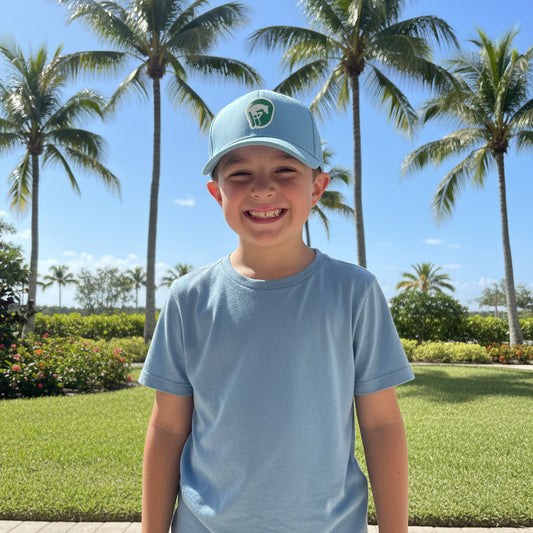 young boy wearing baby blue wef hat outside